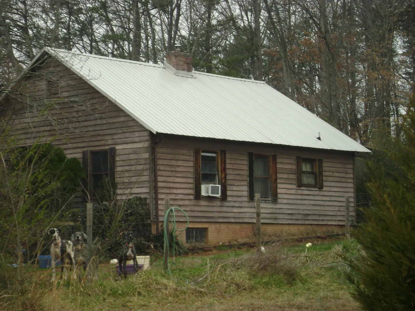 White metal roof on an old wood sided farmhouse, from a Asphalt Shingle Roof Repair job in Norton